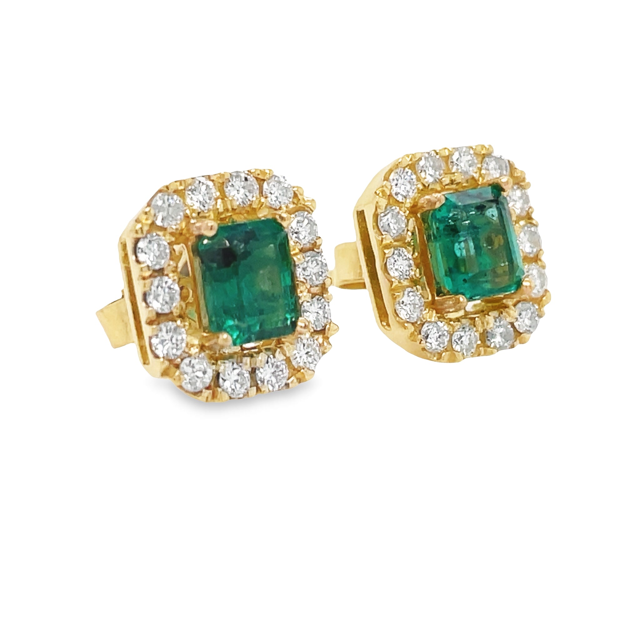 These Colombian emerald stud earrings are expertly crafted with 1.80 cts of emeralds with a 0.40 cts diamond halo set in 18k yellow gold. The emeralds are of very good color and clarity, making them a stunning addition to any jewelry collection.