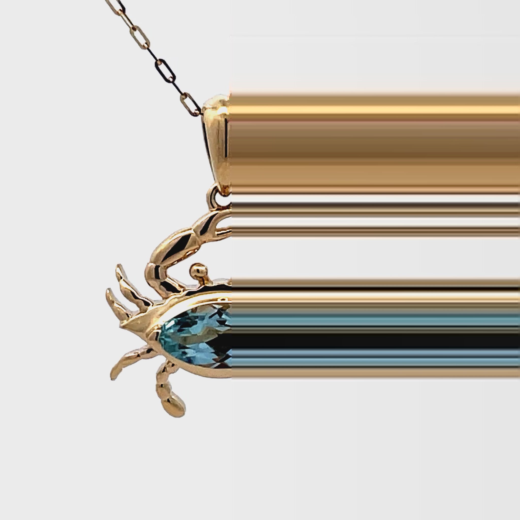 Try on video of 14k Yellow Gold Blue Topaz Crab Pendant Necklace