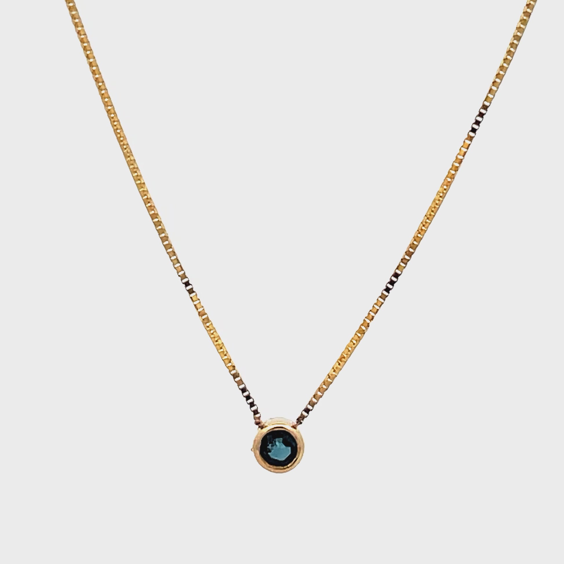 Try on view of 14k Yellow Gold Small Solitaire Sapphire Pendant Necklace 