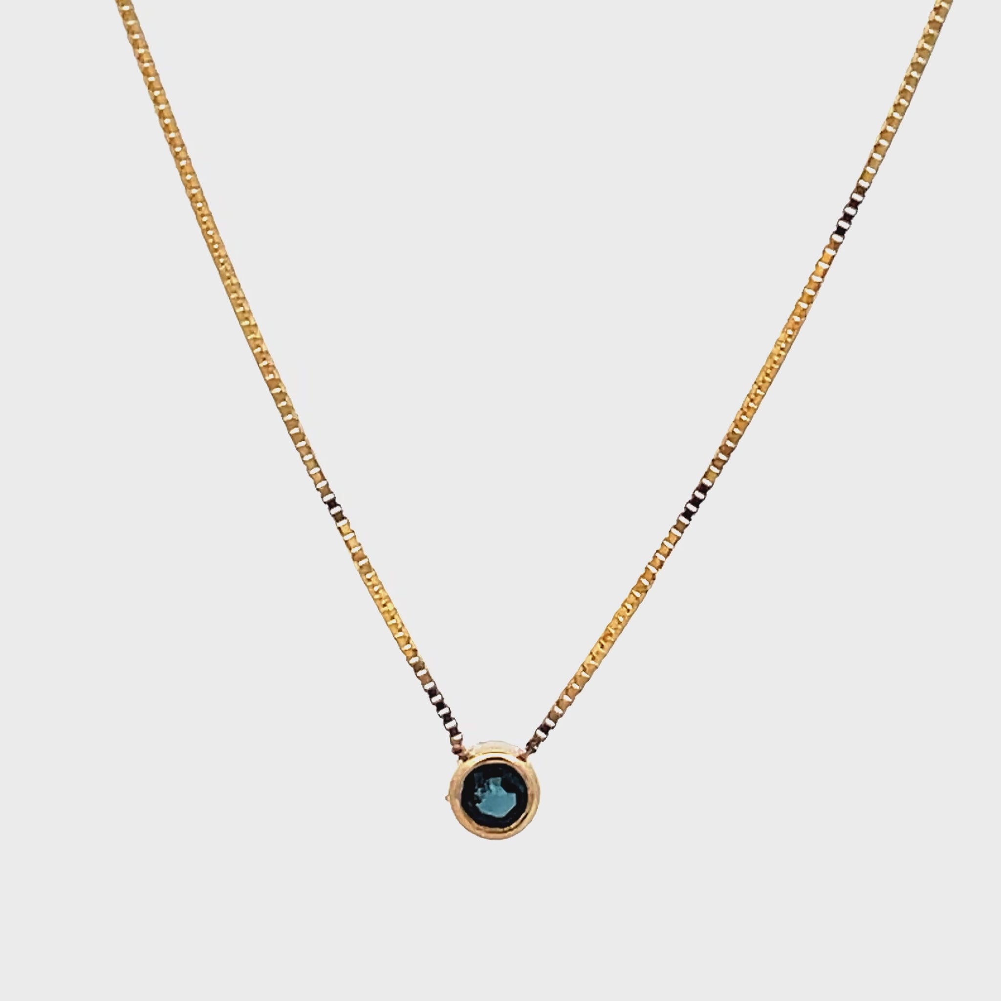 Try on view of 14k Yellow Gold Small Solitaire Sapphire Pendant Necklace 