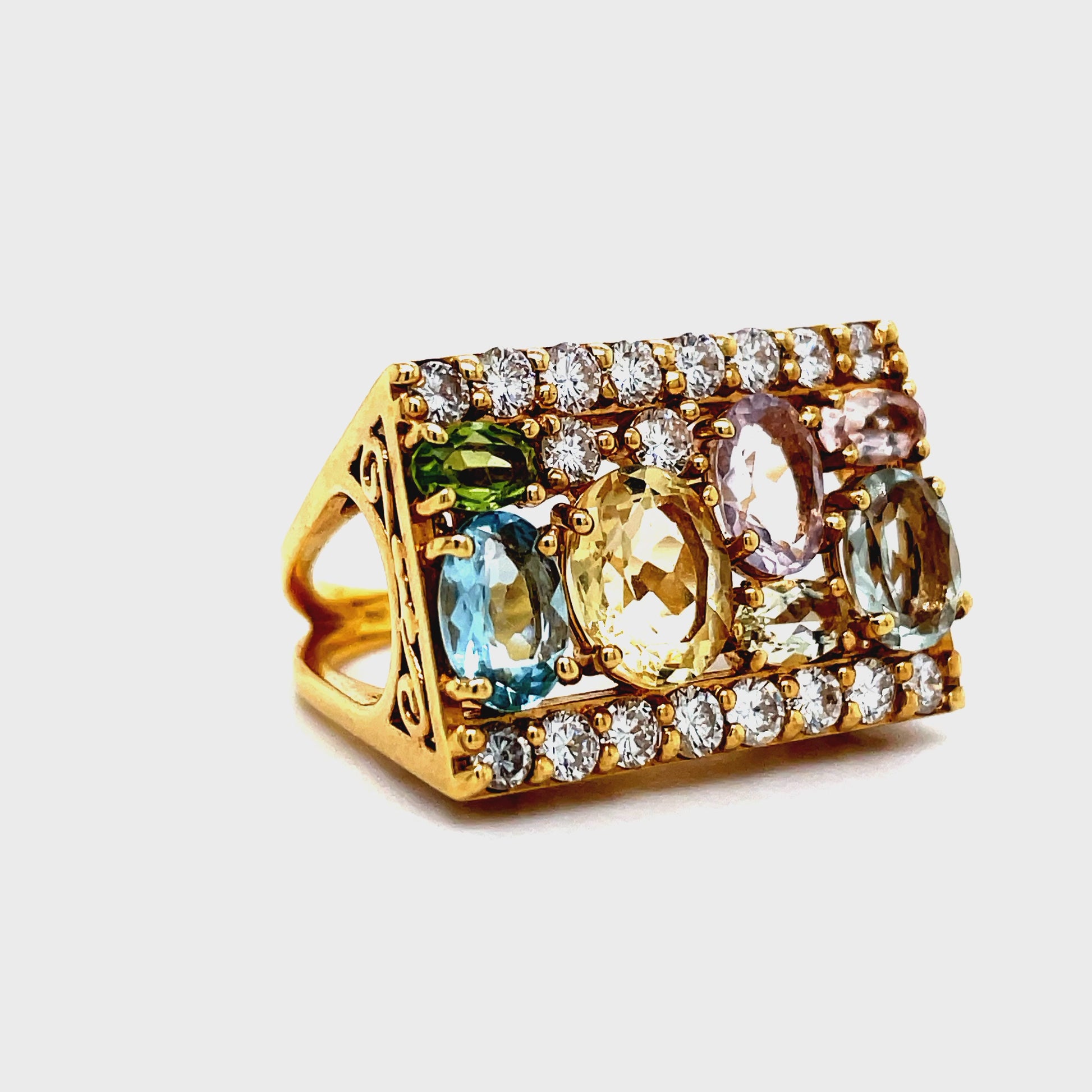 This exquisite 18k yellow gold ring, handcrafted in Brazil, features a stunning combination of blue topaz, citrine light amethyst, and round diamonds totaling 1.37 cts. The gallery finish adds a touch of sophistication to this unique and luxurious piece. Elevate your style with this exclusive fashion ring.