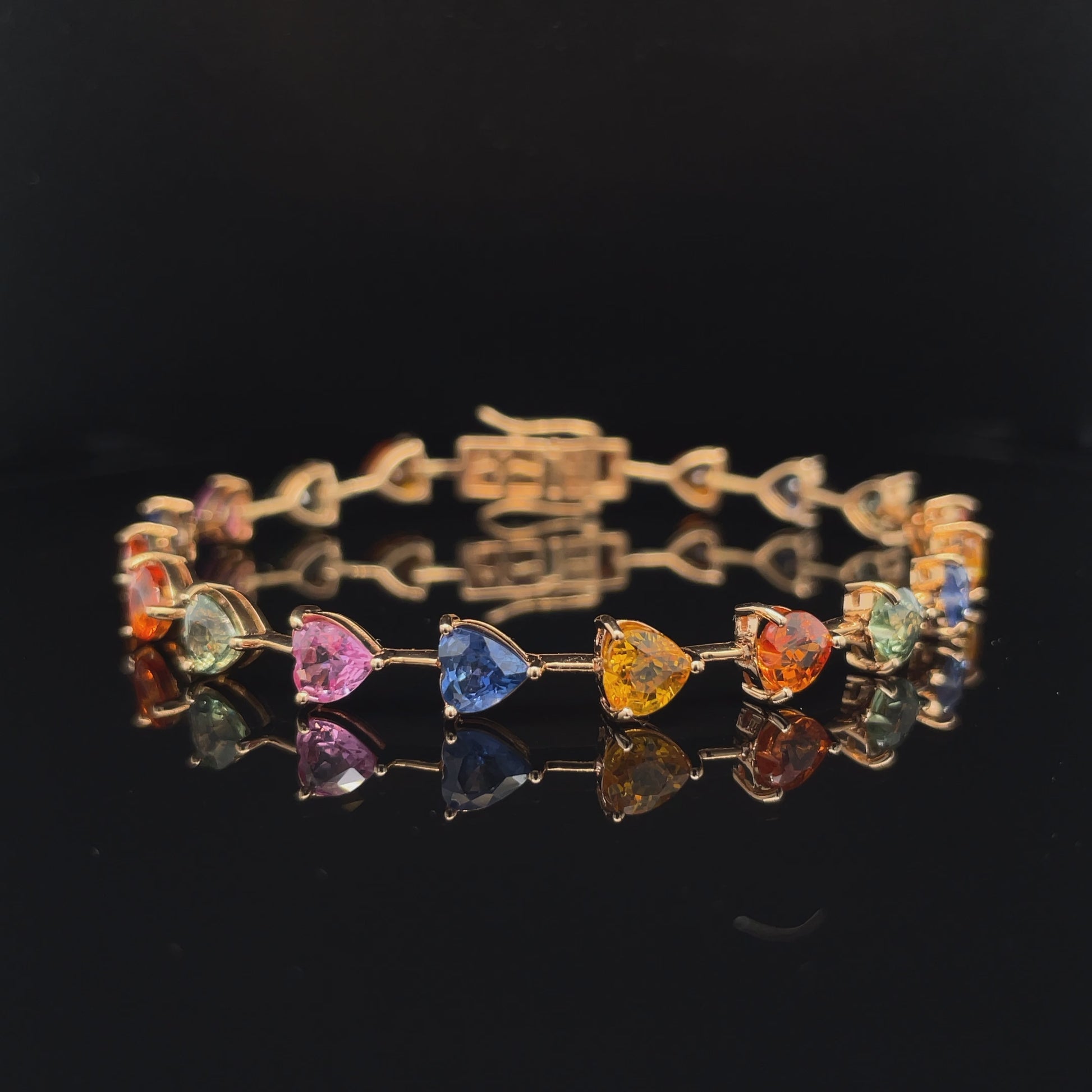This beautiful 18k rose gold bracelet features a heart-shaped multi-colored sapphire totaling 12,007 cts. It's the perfect way to make a glamorous statement with sophistication.
