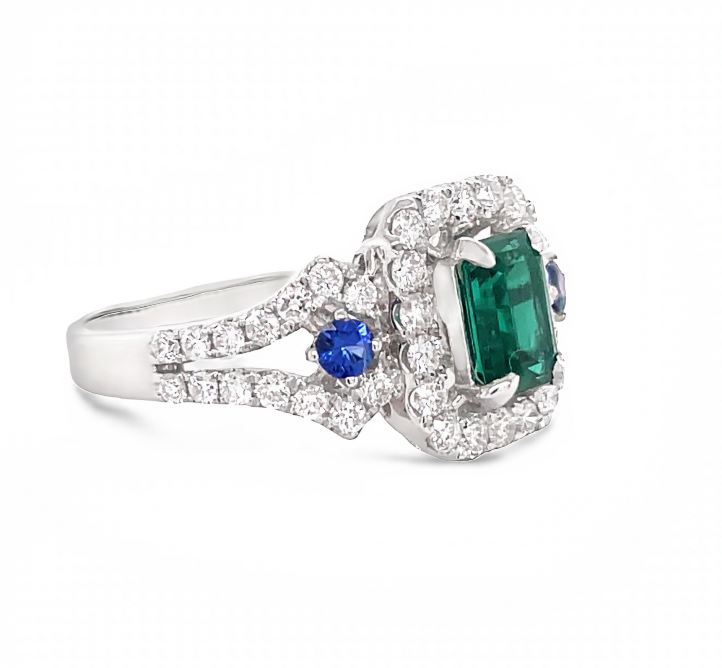 Side view of 18k White Gold Emerald Cut emerald with Diamond Halo & Sapphire Ring