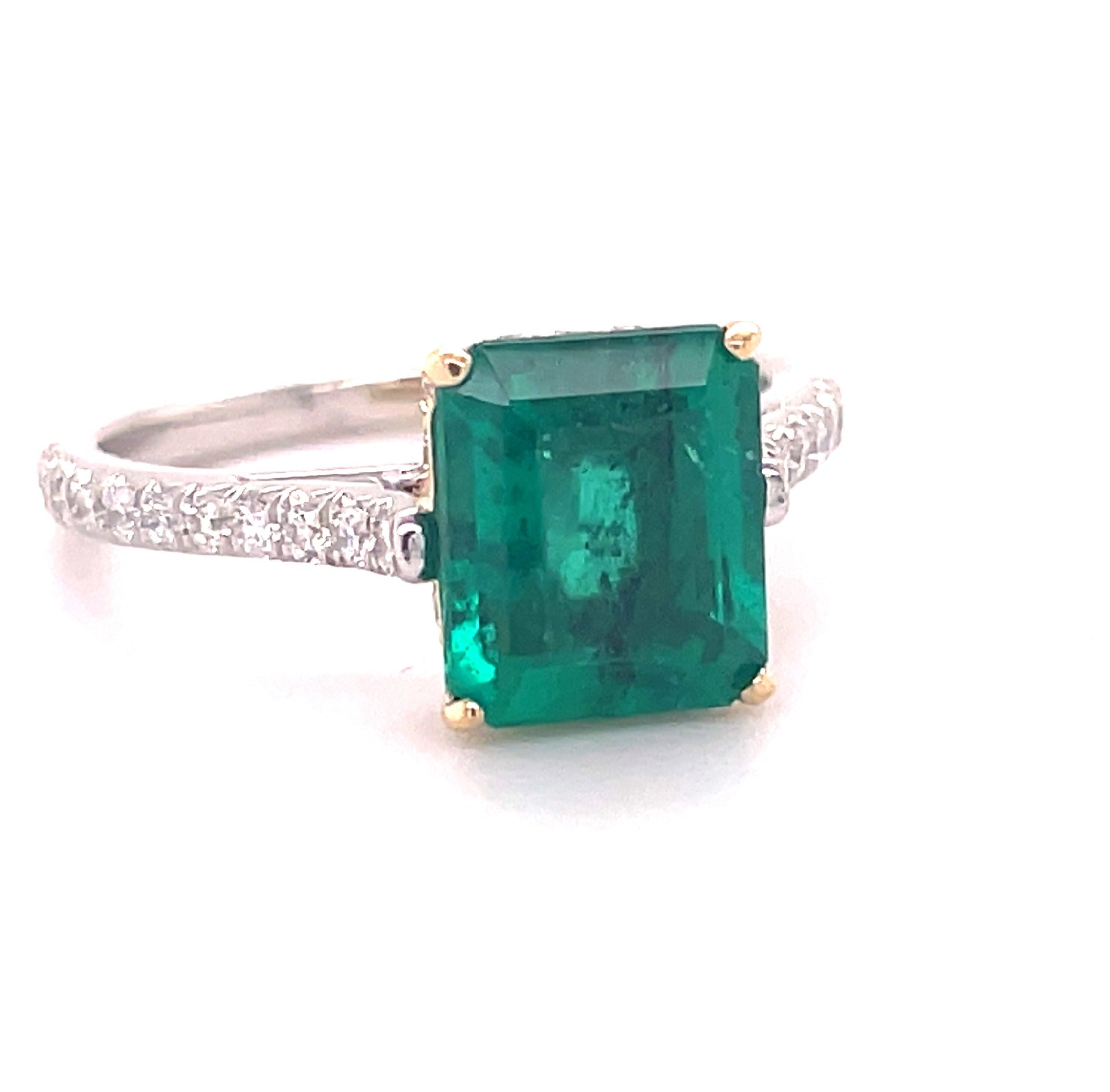 Indulge in timeless elegance with this luxurious Emerald Ring Set in 22k Yellow Gold & Platinum. Featuring a 2.40 ct emerald cut emerald center stone, surrounded by round diamonds 0.60 cts for an exquisite look. Crafted to last, this statement piece will be cherished for years to come.