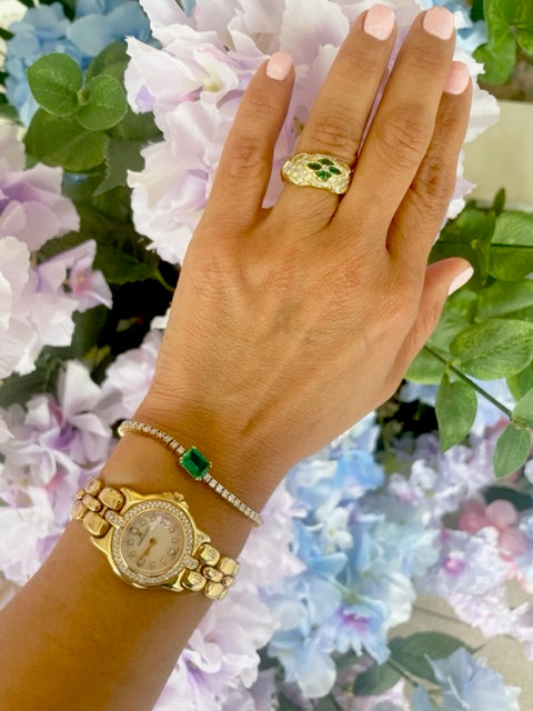 18k yellow gold  Surrounded by white round diamonds    Four marquise emeralds   9.50 mm.